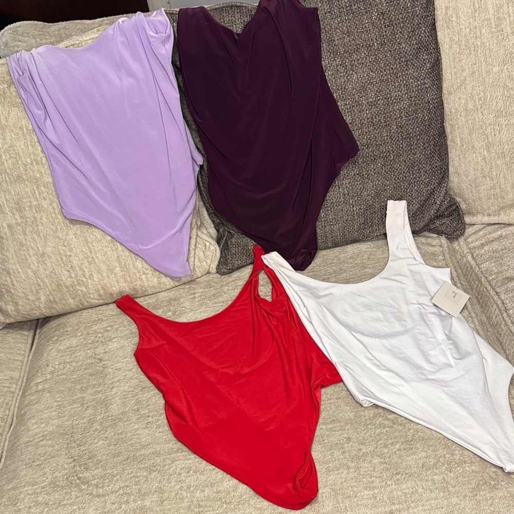 Women's bodysuit bundle of four - Red, White, Purple, and Lilac.